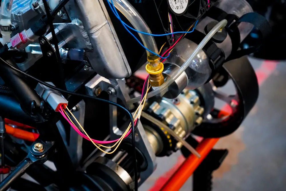 Close-up of coolant lines and wiring on the motor